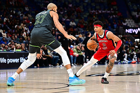 New Orleans Pelicans guard Jeremiah Fears, right, drives with the ball against Minnesota Timberwolves center Rudy Gobert (27) in the second half of an NBA basketball game in New Orleans.