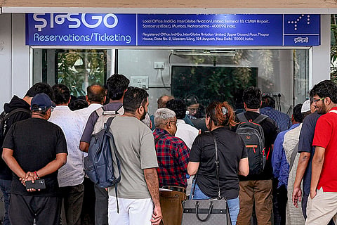 Passengers crowd an IndiGo reservations and ticketing counter after several flights were cancelled at Chhatrapati Shivaji Maharaj International Airport, in Mumbai.
