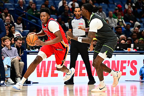 New Orleans Pelicans center Derik Queen, left, drives with the ball against Minnesota Timberwolves center/forward Naz Reid, right, in the second half of an NBA basketball game in New Orleans.