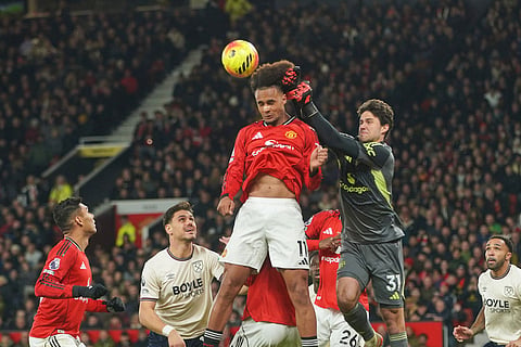 Manchester United's goalkeeper Senne Lammens and Manchester United's Joshua Zirkzee in action during the English Premier League soccer match between Manchester United and West Ham United in Manchester, England.