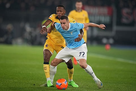 AC Milan's Pervis Estupinan, left, and Lazio's Adam Marusic fight for the ball during the Italian Cup round of sixteen soccer match between Lazio and Milan, in Rome.