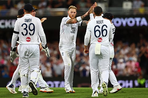 England's captain Ben Stokes, centre, celebrates with teammates the wicket of Australia's Josh Inglis during the second Ashes cricket test match between Australia and England in Brisbane.