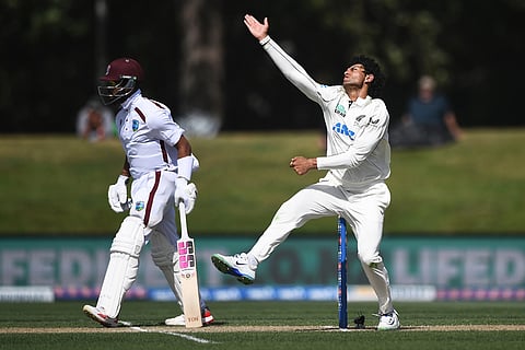 New Zealand's Rachin Ravindra, right, bowls as West Indies' Justin Greaves prepares to run on Day 4 of their cricket test match in Christchurch, New Zealand.