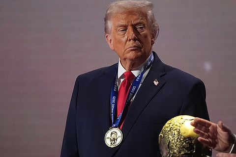 US President Donald Trump stands on stage after receiving the FIFA Peace Prize during the draw for the 2026 soccer World Cup at the Kennedy Center in Washington.