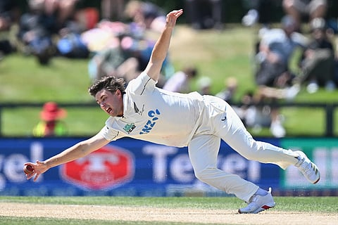 New Zealand's Zak Foulkes fields off his own bowling to the West Indies on Day 5 of their cricket test match in Christchurch, New Zealand.