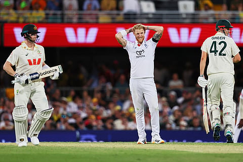 England's captain Ben Stokes, centre, reacts after bowls a delivery during the second Ashes cricket test match between Australia and England in Brisbane.
