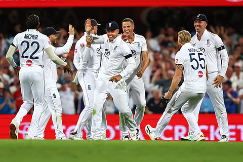 England's Will Jacks, centre, celebrates with teammates the wicket of Australia's captain Steve Smith during the second Ashes cricket test match between Australia and England in Brisbane.