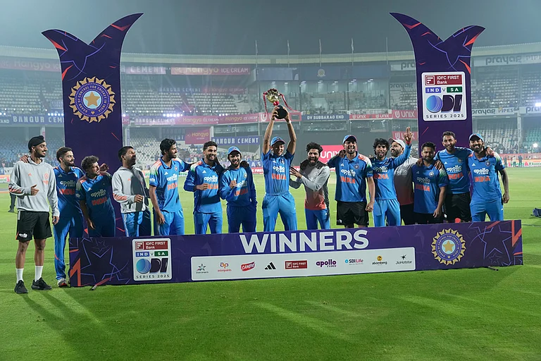 Indian players pose with the trophy after winning the third One Day International cricket match against South Africa in Visakhapatnam. India won the series by 2-1. - | Photo: AP/Mahesh Kumar A.