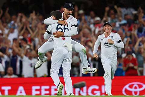 England's Will Jacks jumps to celebrate with teammate England's Joe Root the wicket of Australia's captain Steve Smith during the second Ashes cricket test match between Australia and England in Brisbane.