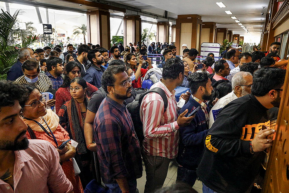 | Photo: PTI : Stranded passengers wait in queues to enquire about flight status at Sardar Vallabhbhai Patel International Airport amid IndiGo flight disruptions, in Ahmedabad.