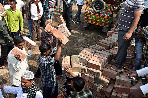 People carry bricks in view of former TMC MLA Humayun Kabir's plan to lay the foundation stone for a mosque, modelled on Ayodhya’s Babri Masjid, at Rejinagar in West Bengal’s Murshidabad district, escalating political temperatures in the state.