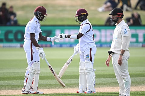 West Indies' Justin Greaves, left, and Kemar Roach encourage each other while batting against New Zealand on Day 5 of their cricket test match in Christchurch, New Zealand.