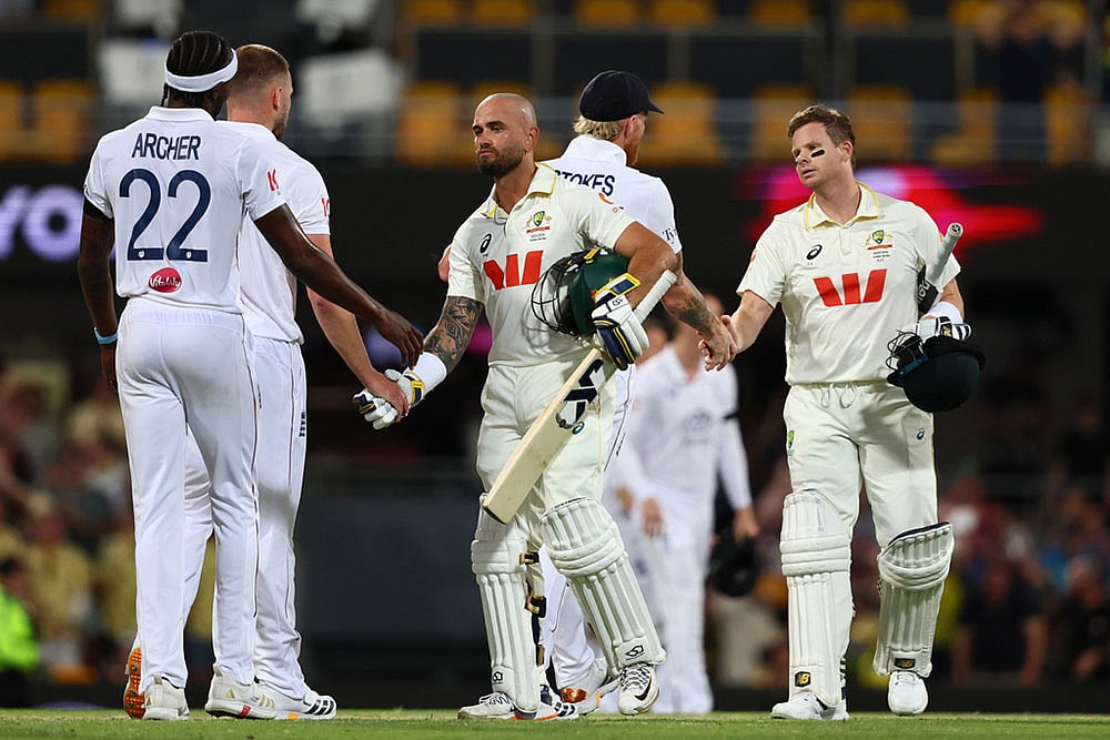 | Photo: AP/Tertius Pickard : Australia's Jake Weatherald, front, and Australia's captain Steve Smith shake hands with England's players after winning the second Ashes cricket test match between Australia and England in Brisbane.
