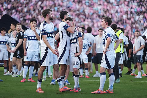 Vancouver Whitecaps' Daniel Rios (second left) consoles Sebastian Berhalter as Thomas Muller (left) reacts after losing to Inter Miami in the MLS Cup final soccer match, in Fort Lauderdale, Fla.