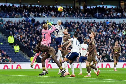 Brentford goalkeeper Caoimhin Kelleher, top left, clears the ball during the English Premier League soccer match between Tottenham Hotspur and Brentford in London.