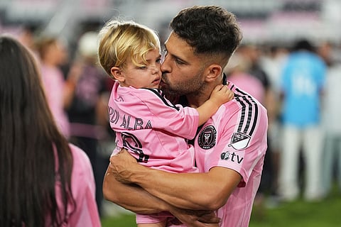 Inter Miami defender Jordi Alba hugs his son after the team won the MLS Cup against the Vancouver Whitecaps in Fort Lauderdale, Fla.