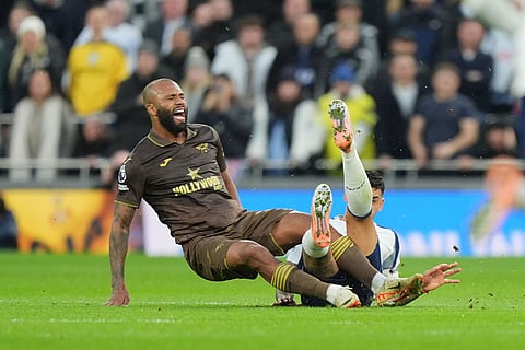 Tottenham Hotspur's Cristian Romero, right, fouls Brentford's Igor Thiago during  during the English Premier League soccer match between Tottenham Hotspur and Brentford in London.