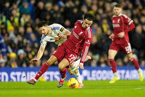 Leeds United's Anton Stach, left, and Liverpool's Curtis Jones in action during the English Premier League soccer match between Leeds United and Liverpool in Leeds, England.