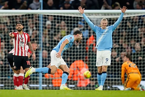 Manchester City's Ruben Dias, centre, celebrates after scoring his side's opening goal during the English Premier League soccer match between Manchester City and Sunderland in Manchester, England.