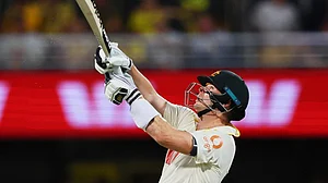 | Photo: AP/Tertius Pickard : Australia's captain Steve Smith hits a six during the second Ashes cricket test match between Australia and England in Brisbane.