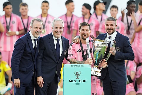 Inter Miami owners Jose Mas, left, his brother Jorge Mas and David Beckham pose with the MLS Cup trophy with forward Lionel Messi in Fort Lauderdale, Fla.
