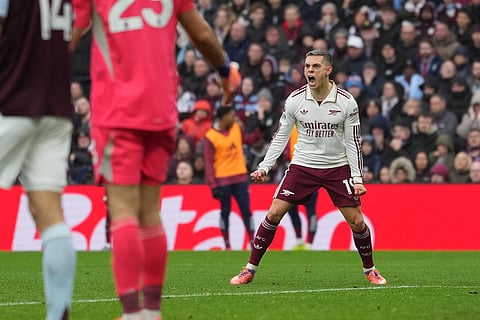 Arsenal's Leandro Trossard celebrates after scoring his side's opening goal during the English Premier League soccer match between Aston Villa and Arsenal in Birmingham, England.