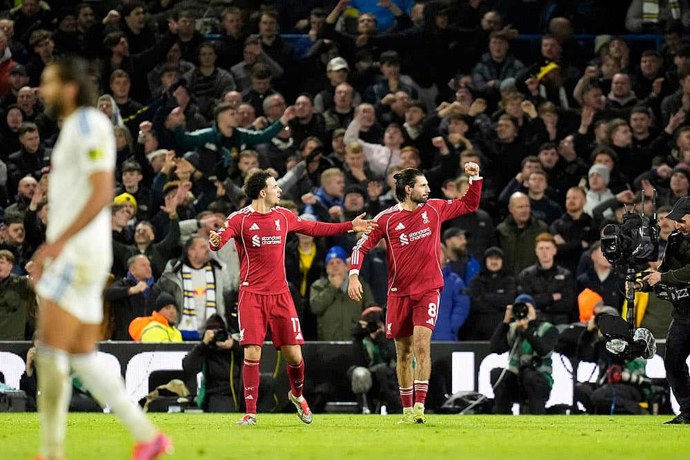 | Photo: Danny Lawson/PA via AP : Liverpool's Dominik Szoboszlai celebrates scoring during the English Premier League soccer match between Leeds United and Liverpool in Leeds, England.