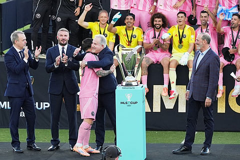 Inter Miami forward Lionel Messi (10) is hugged by Jorge Mas Jr., managing owner of the team, after winning the MLS Cup against the Vancouver Whitecaps in Fort Lauderdale, Fla.