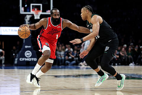 Los Angeles Clippers guard James Harden, left, works around Minnesota Timberwolves center Rudy Gobert (27) during the second half of an NBA basketball game in Minneapolis. 