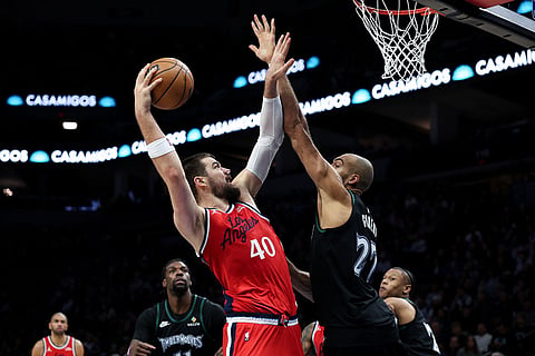 Los Angeles Clippers center Ivica Zubac (40) looks to shoot as Minnesota Timberwolves center Rudy Gobert (27) defends during the second half of an NBA basketball game in Minneapolis.
