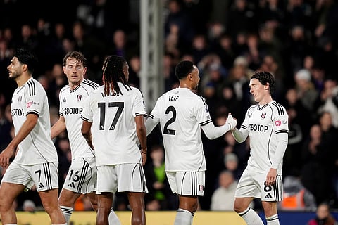 Fulham's Harry Wilson, right, celebrates with his teammates after scoring his sides first goal during the English Premier League soccer match between Fulham and Crystal Palace, in London.