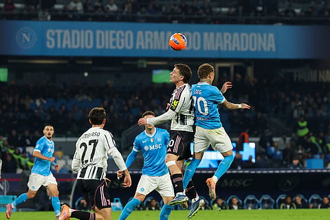 Juventus' Kenan Yildiz, top left, and Napoli's Noa Lang challenge for the ball during the Serie A soccer match between Napoli and Juventus, in Naples, Italy.