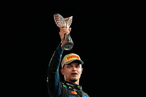 McLaren driver Lando Norris of Britain celebrates after becoming a world champion after the Formula One Abu Dhabi Grand Prix at the Yas Marina Circuit in Abu Dhabi, UAE.