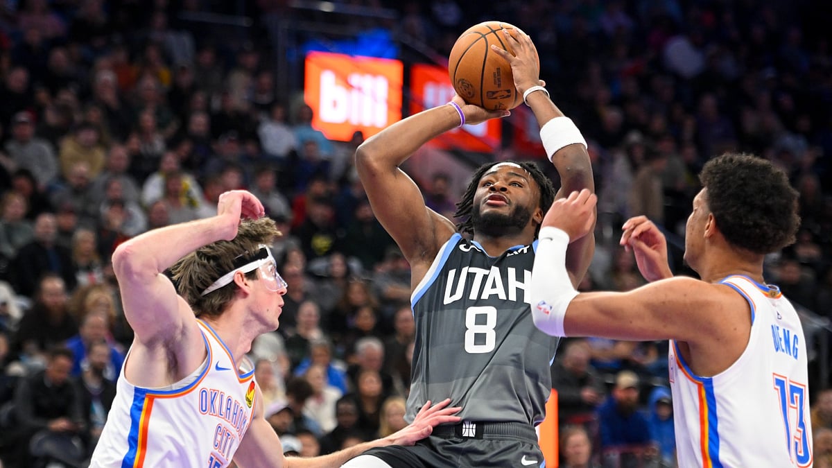 Isaiah Collier #8 of the Utah Jazz shoots over Branden Carlson #15 of the Oklahoma City Thunder during the first half of a game at Delta Center on December 07, 2025 in Salt Lake City, Utah.