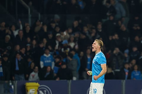Napoli's Rasmus Hojlund celebrates after scoring the opening goal during the Serie A soccer match between Napoli and Juventus, in Naples, Italy.
