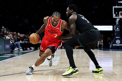 Los Angeles Clippers forward Kawhi Leonard, left, works around Minnesota Timberwolves forward Julius Randle (30) during the second half of an NBA basketball game in Minneapolis.