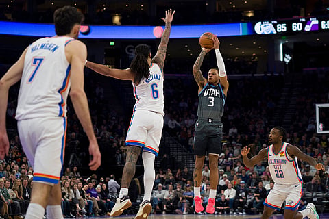 Utah Jazz guard Keyonte George (3) prepares to shoot as Oklahoma City Thunder forward Jaylin Williams (6) blocks and guard Cason Wallace (22) and center/forward Chet Holmgren (7) defend during the second half of an NBA basketball game in Salt Lake City.