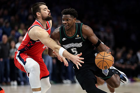 Minnesota Timberwolves guard Anthony Edwards, right, works around Los Angeles Clippers center Ivica Zubac (40) during the first half of an NBA basketball game in Minneapolis. 