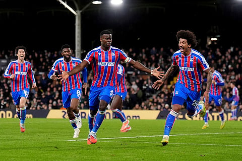 Crystal Palace's Marc Guehi, centre, celebrates after scoring his sides second goal during the English Premier League soccer match between Fulham and Crystal Palace, in London.