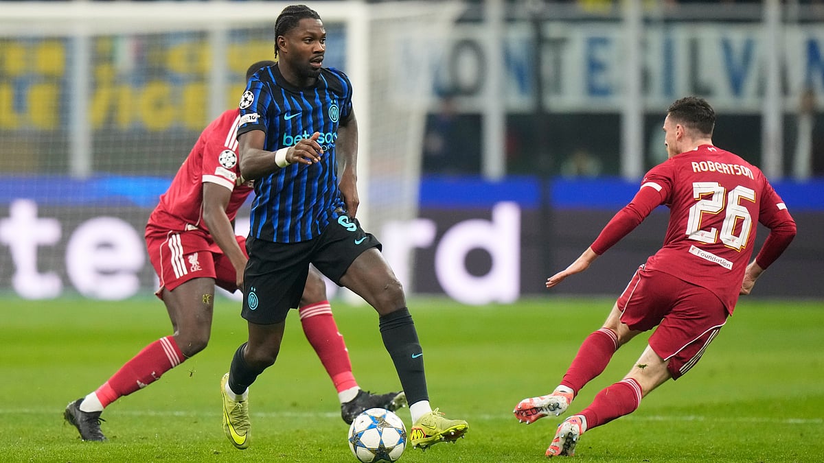 | Photo: AP/Luca Bruno : Inter Milan's Marcus Thuram challenges for the ball with Liverpool's Andrew Robertson during their UEFA Champions League  league phase match on December 9, 2025.