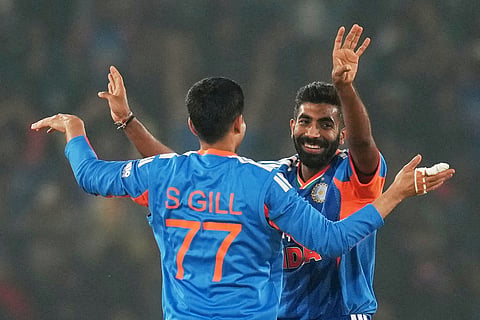 India's Jasprit Bumrah celebrates with India's Shubman Gill the wicket of South Africa's Keshav Maharaj during the first T20 International cricket match between India and South Africa in Cuttack.