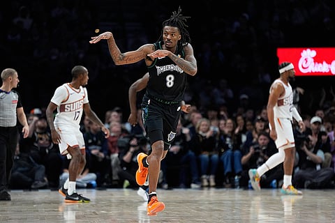 Minnesota Timberwolves guard Bones Hyland (8) celebrates after making a shot during the second half of an NBA basketball game against the Phoenix Suns in Minneapolis. 