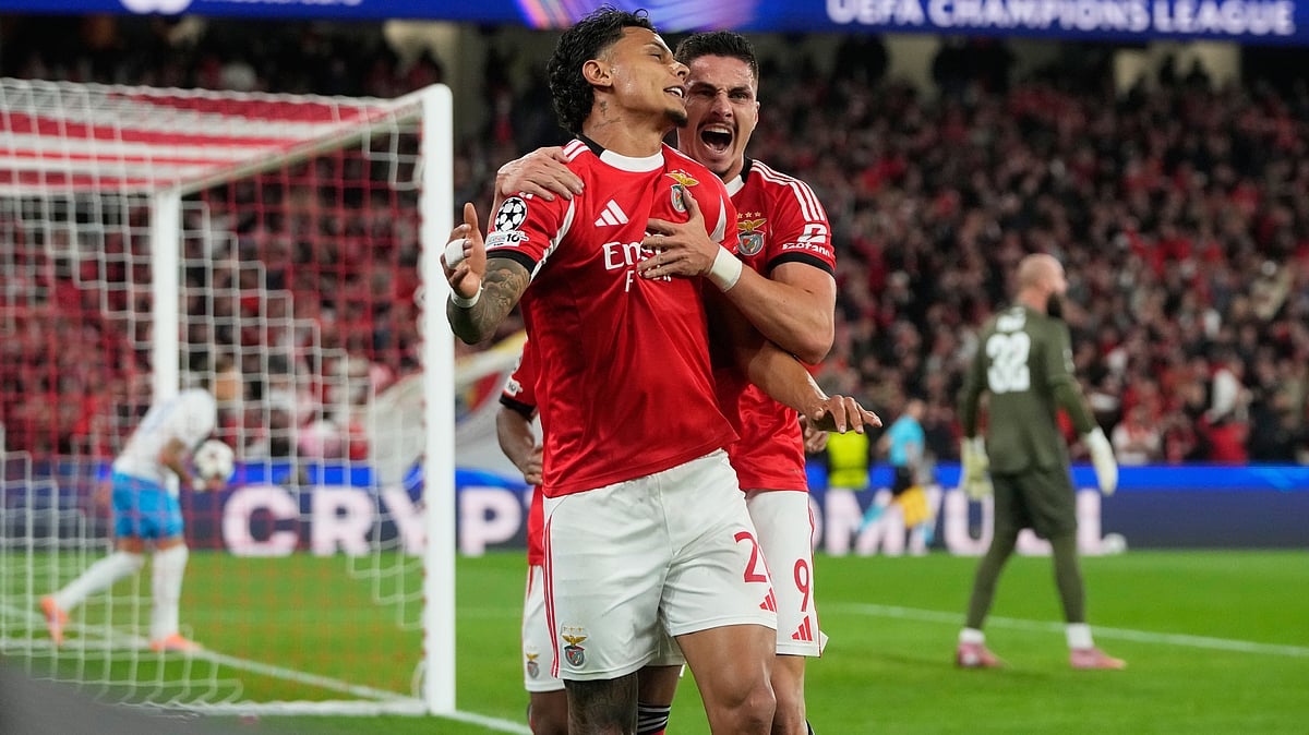 | Photo: AP/Armando Franca : SL Benfica's Richard Rios celebrates with Franjo Ivanovic after scoring his side's first goal during the UEFA Champions League opening phase match against Napoli on December 10, 2025.