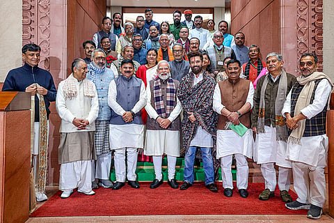 In this image posted on Dec. 8, 2025, Prime Minister Narendra Modi pose for a photograph with Bihar NDA MPs at the Parliament complex, in New Delhi.