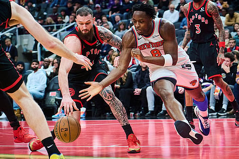New York Knicks' OG Anunoby (8) and Toronto Raptors' Sandro Mamukelashvili, left, vie for the ball during the second half of an NBA Cup basketball game in Toronto.
