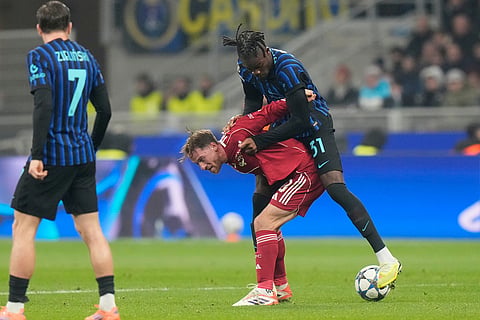 Liverpool's Alexis Mac Allister challenges for the ball with Inter Milan's Yann Bisseck during a Champions League, league phase, soccer match between Inter Milan and Liverpool in Milan, Italy.