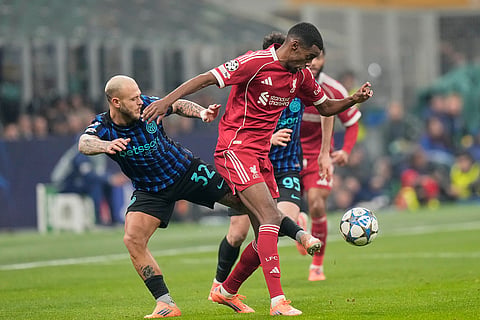 Liverpool's Alexander Isak, right, challenges for the ball with Inter Milan's Federico Dimarco during a Champions League, league phase, soccer match between Inter Milan and Liverpool in Milan, Italy.