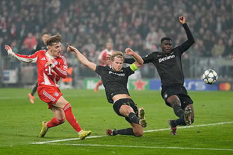 Bayern's Lennart Karl, left, scores his side's second goal during the Champions League opening phase soccer match between FC Bayern Munich and Sporting CP in Munich, Germany.
