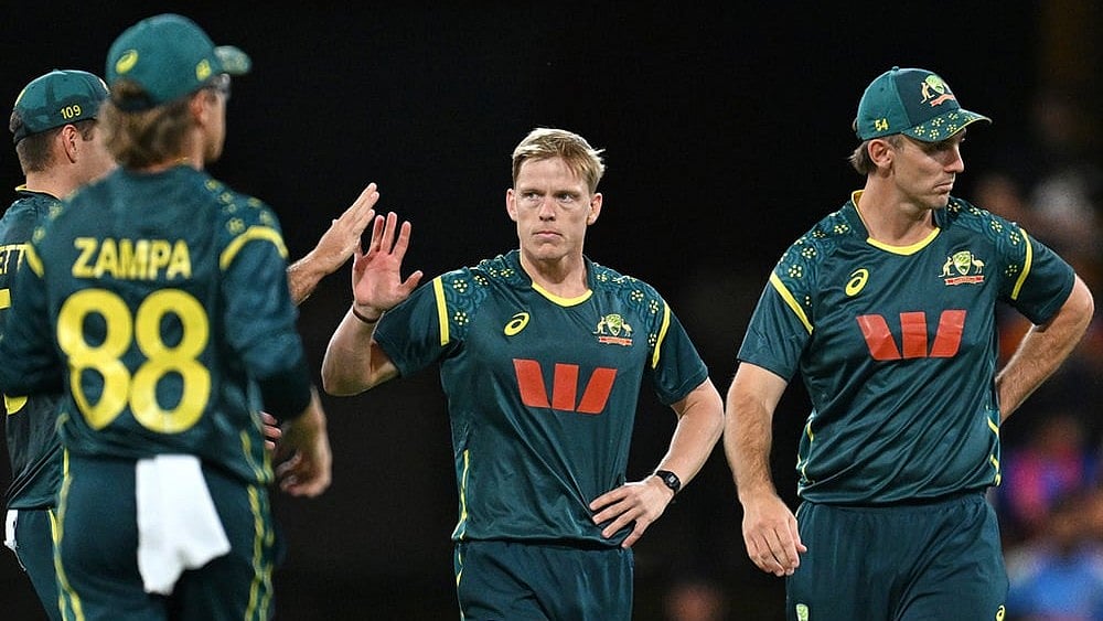 | Photo: Dave Hunt/AAPImage via AP : Australia's Nathan Ellis, centre, celebrates with teammates after dismissing Indian batsman Shivam Dube during a T20 cricket international between India and Australia in Carrara, Australia.