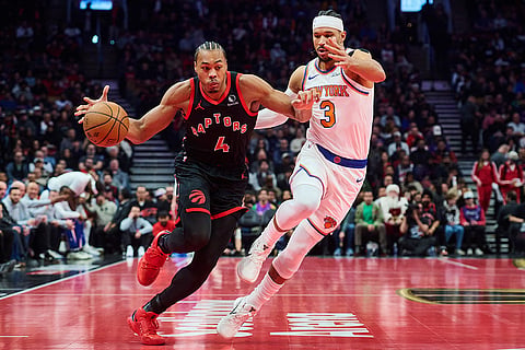 Toronto Raptors' Scottie Barnes (4) drives past New York Knicks' Josh Hart (3) during the first half of an NBA Cup basketball game in Toronto.